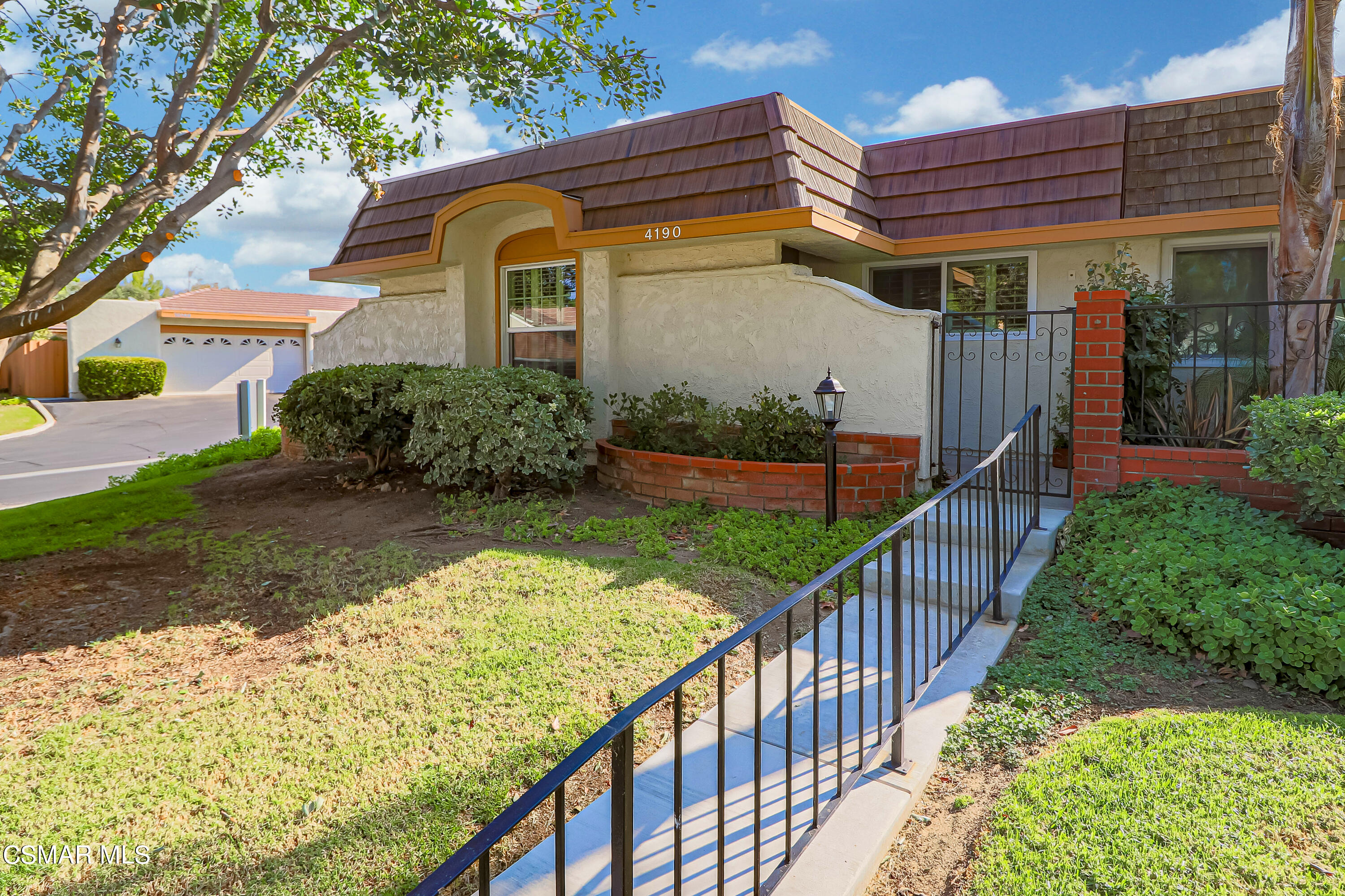 a view of a house with wooden fence