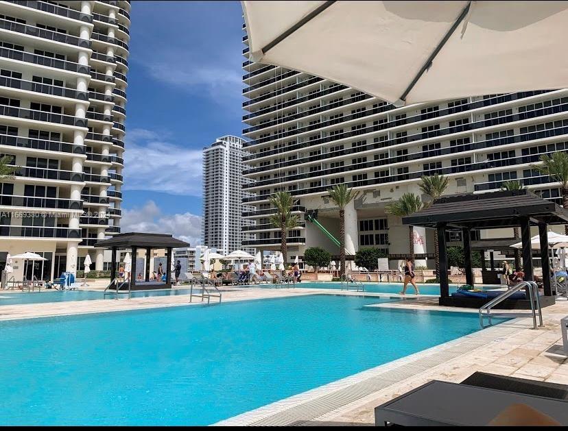 a view of a swimming pool with outdoor seating