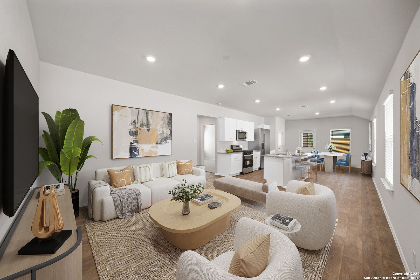 a living room with furniture and a wooden floor