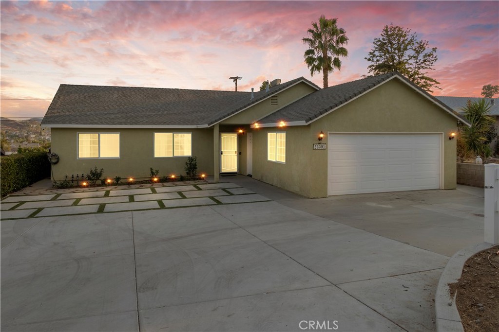 a view of house with outdoor space and parking