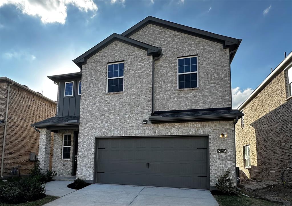 a front view of a house with garage