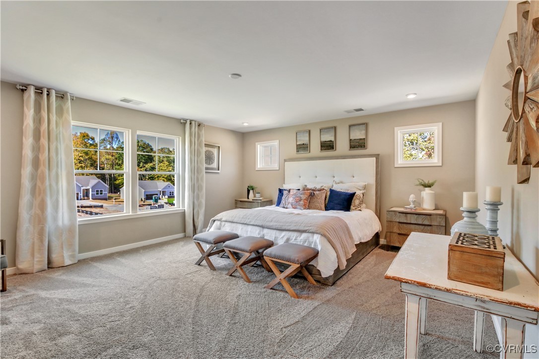 a spacious bedroom with a bed and glass door