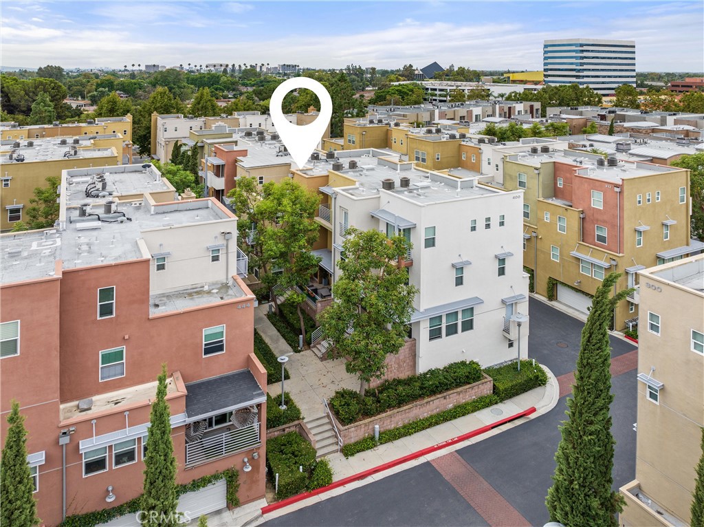 a aerial view of a house with outdoor space and city view