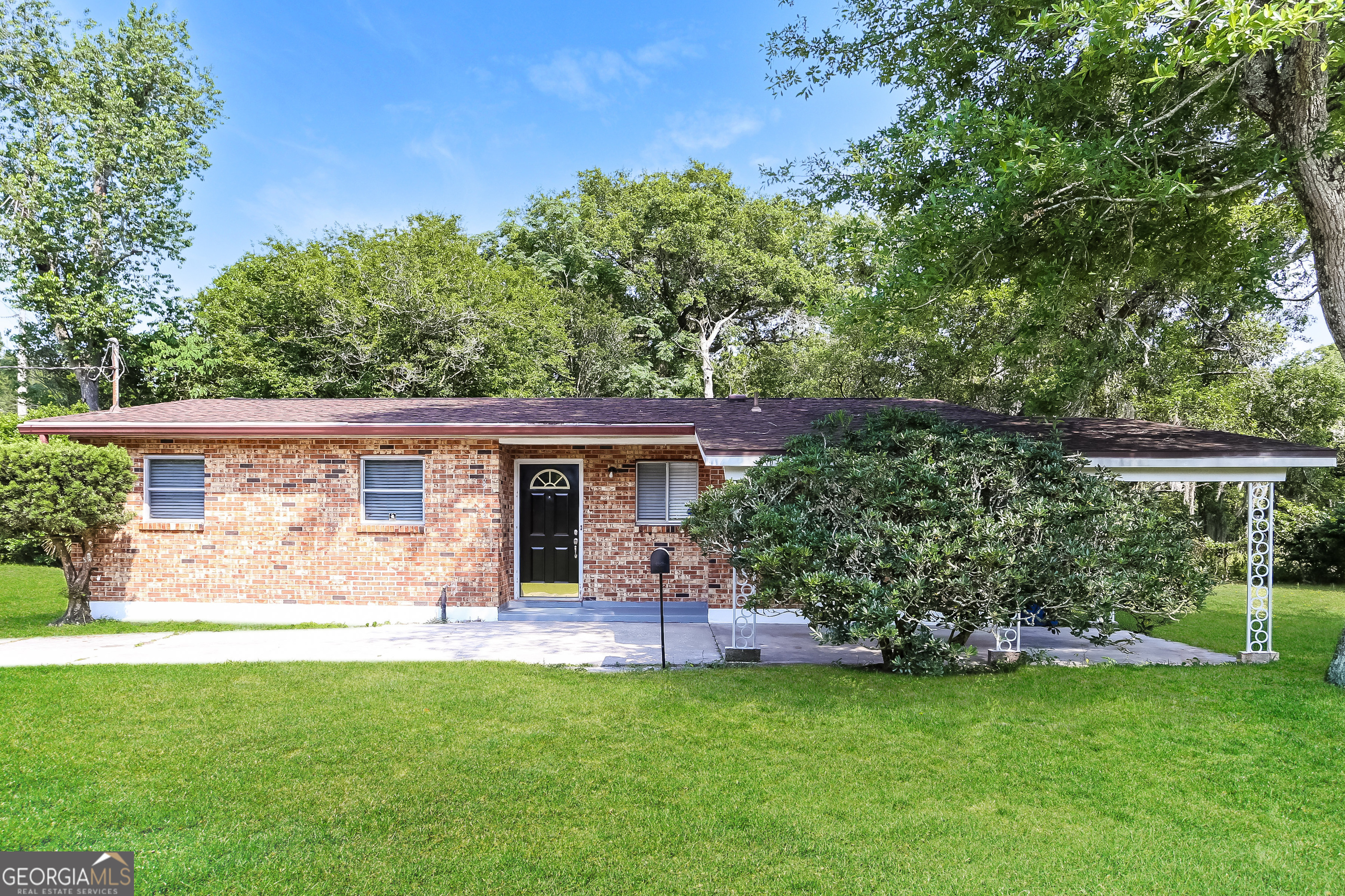 a front view of house with yard and green space