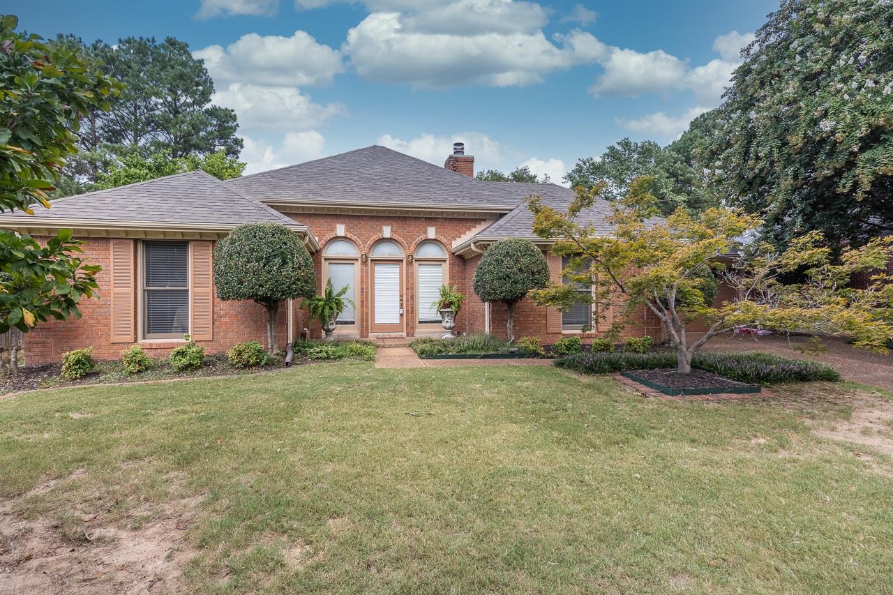 a front view of a house with a yard