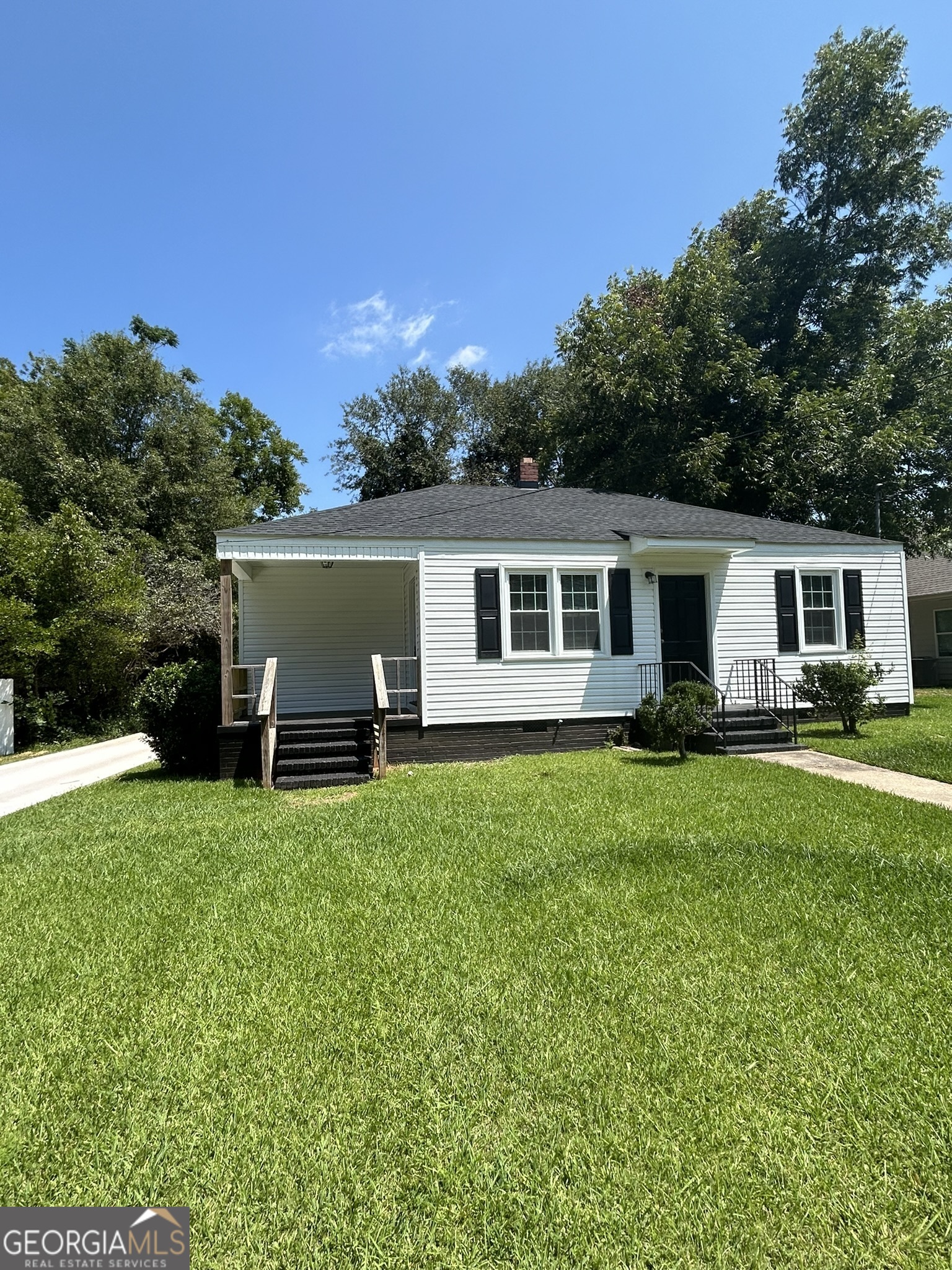 a front view of house with yard and trees