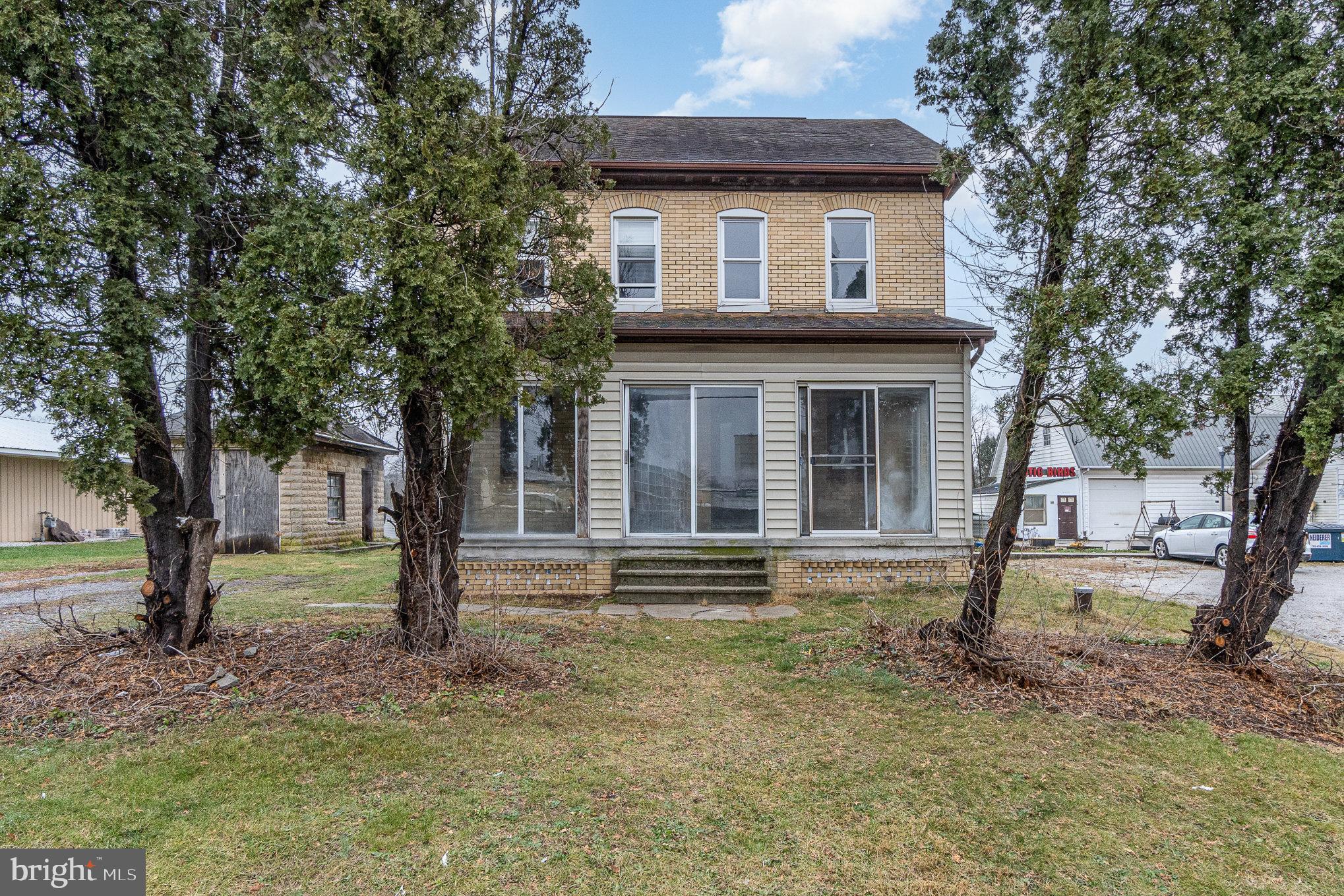 a front view of a house with a garden