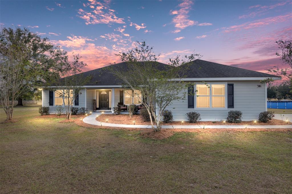 a front view of a house with garden and patio