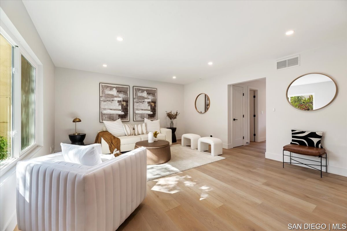 a bedroom with furniture and a large window