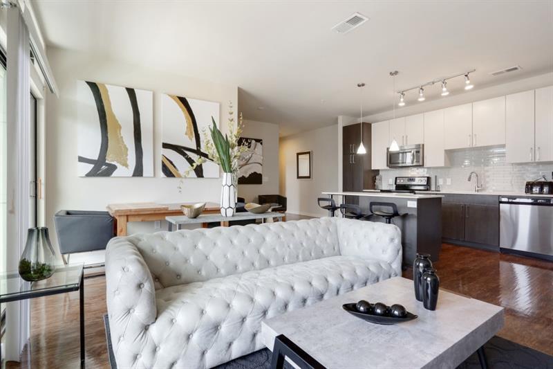 a living room with furniture kitchen and a table