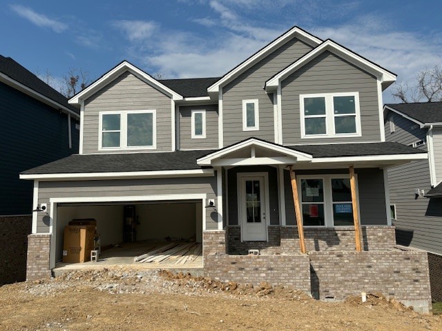 a front view of a house with yard and parking space