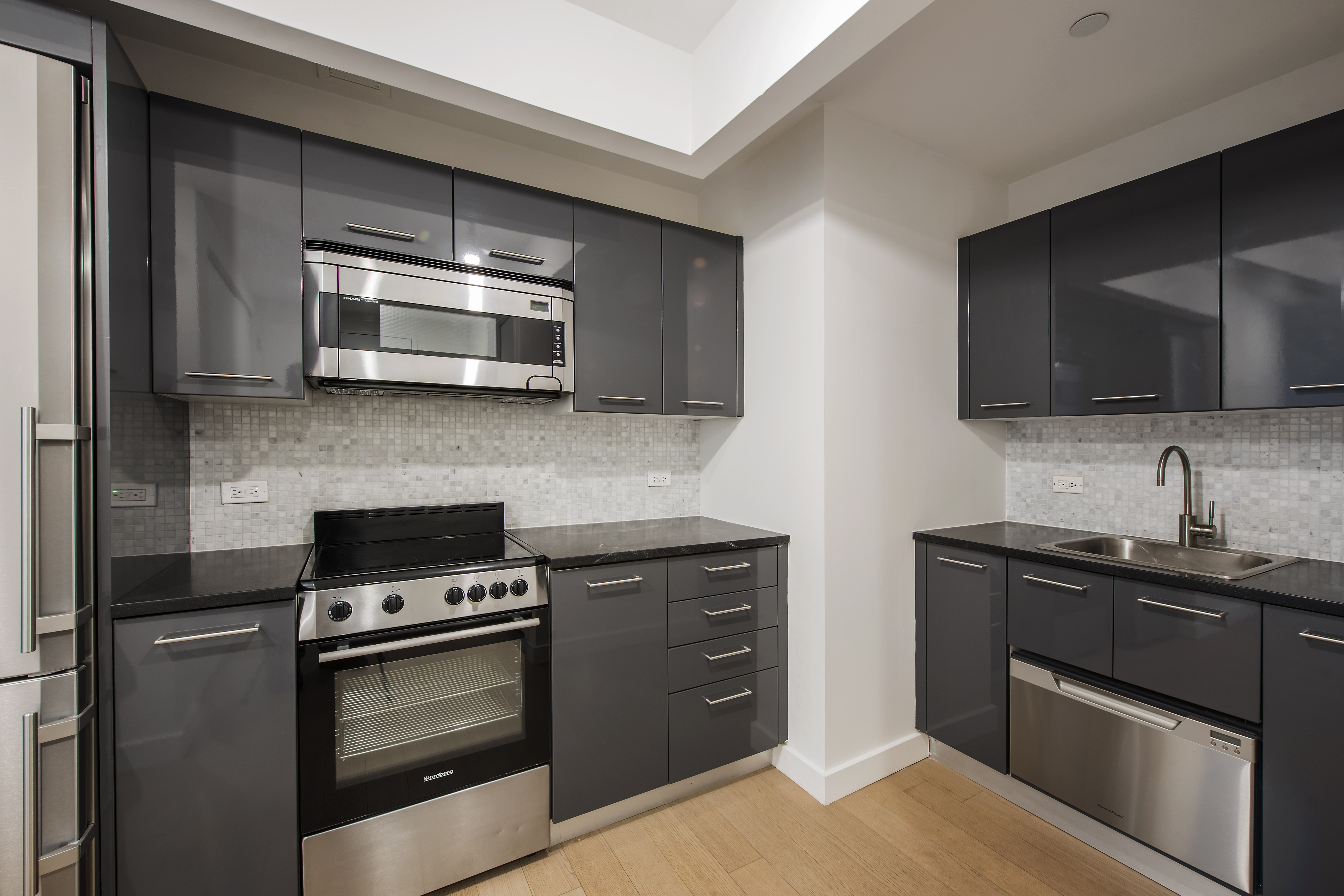 a kitchen with stainless steel appliances wooden cabinets and a stove top oven