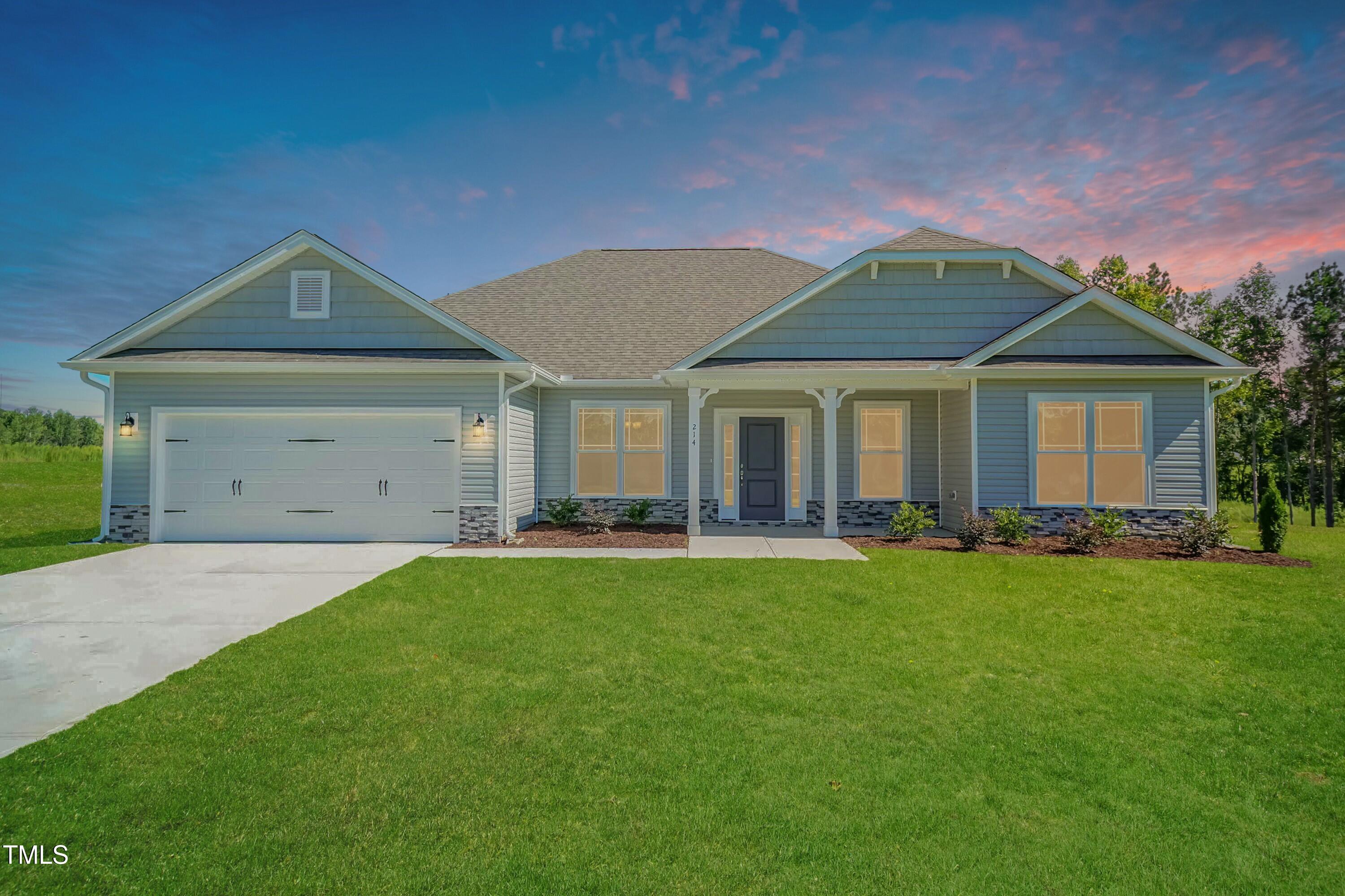 a front view of a house with a garden and porch