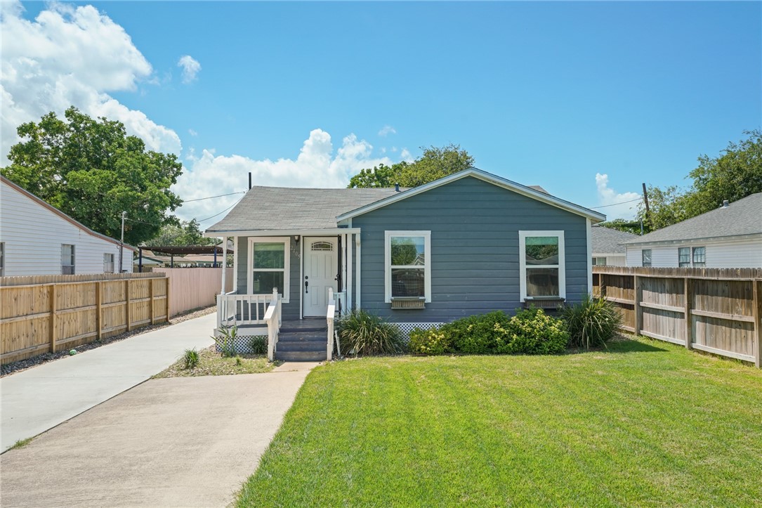 a front view of house with yard and outdoor seating