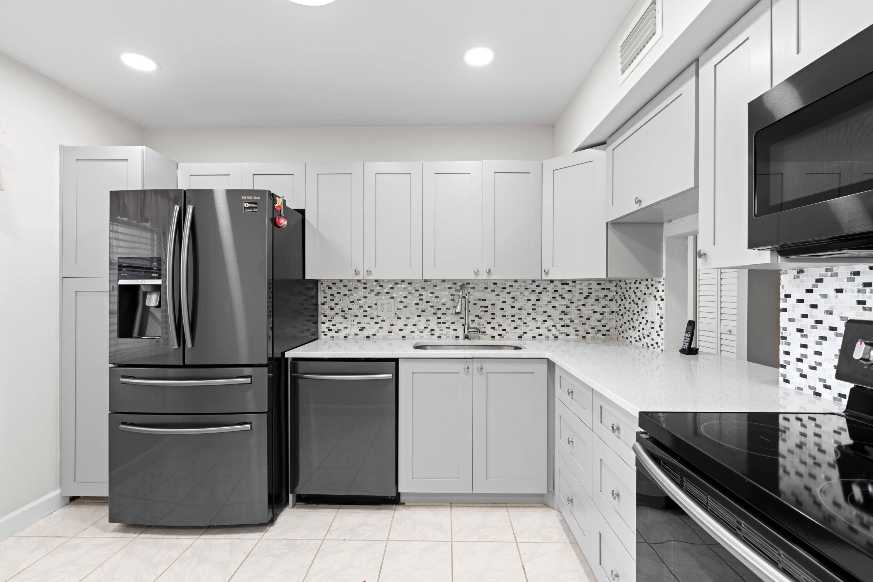 a kitchen with stainless steel appliances granite countertop a refrigerator and a stove