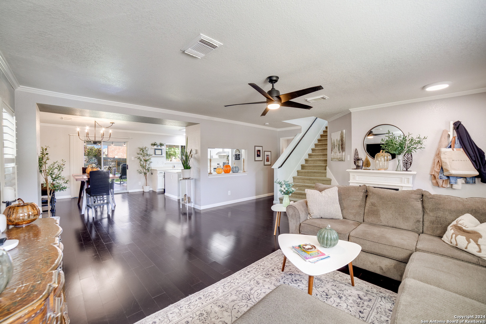 a living room with furniture and wooden floor