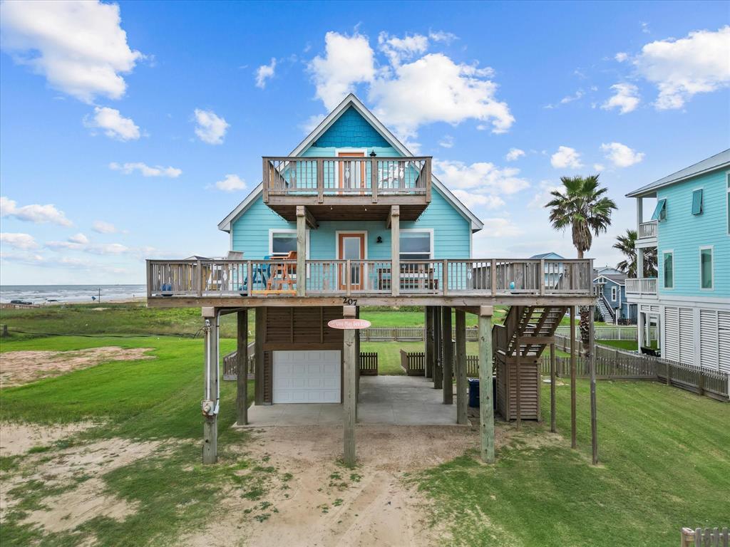 a view of a house with a yard balcony and sitting area