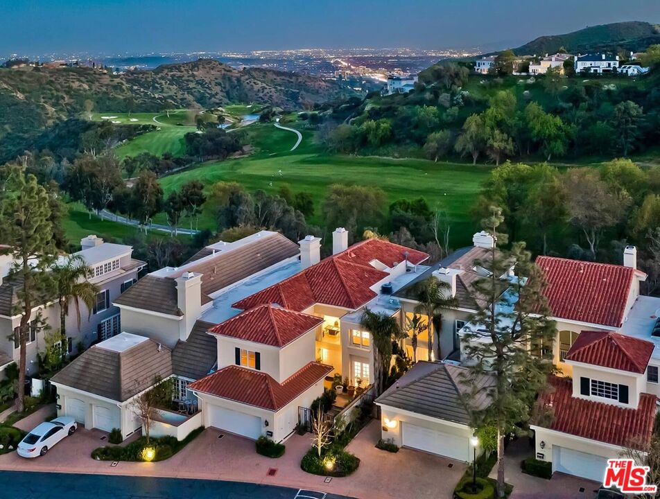 an aerial view of a house with garden space and street view