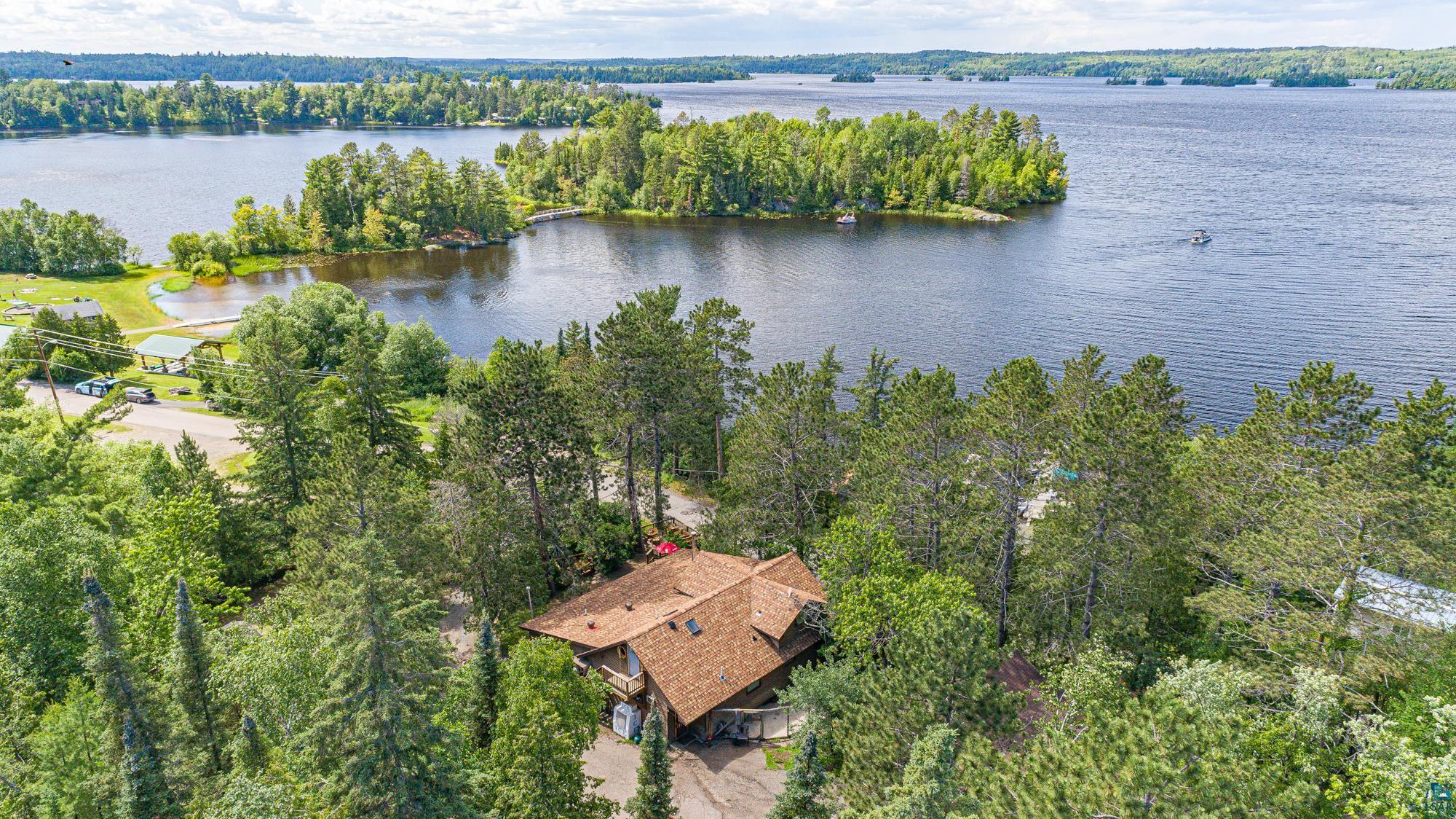 Birds eye view of property with a water view