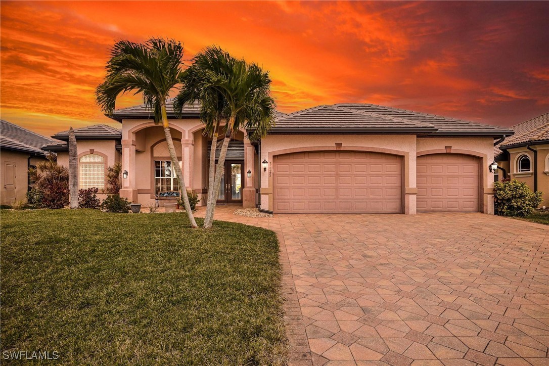 a front view of a house with a yard and garage