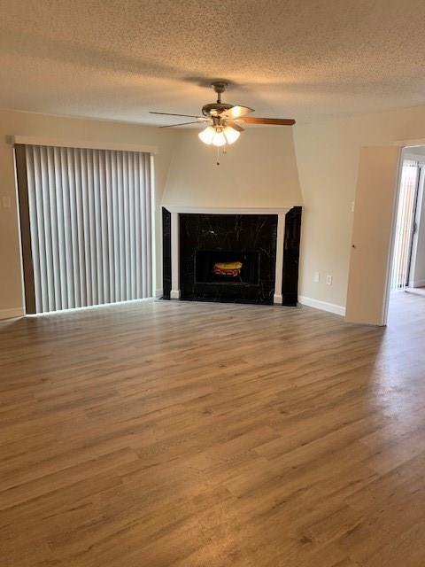 a view of a livingroom with a fireplace and wooden floor