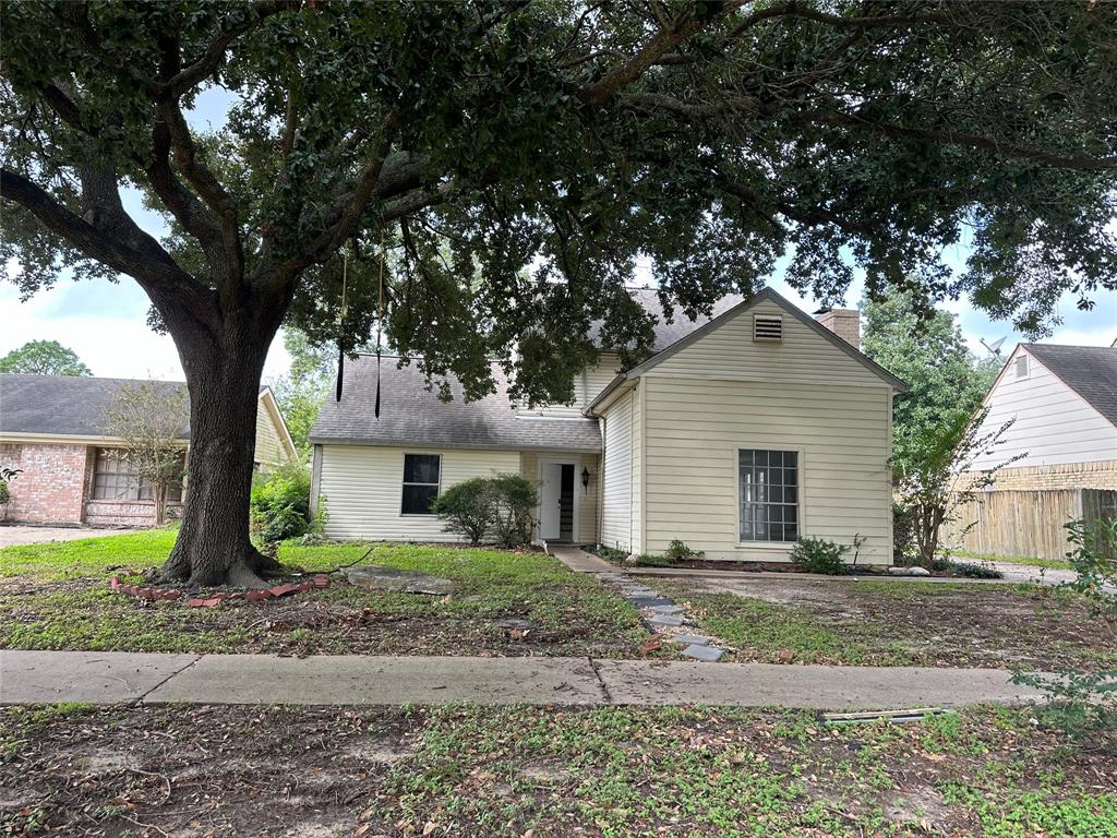 a house that has a tree in front of the house