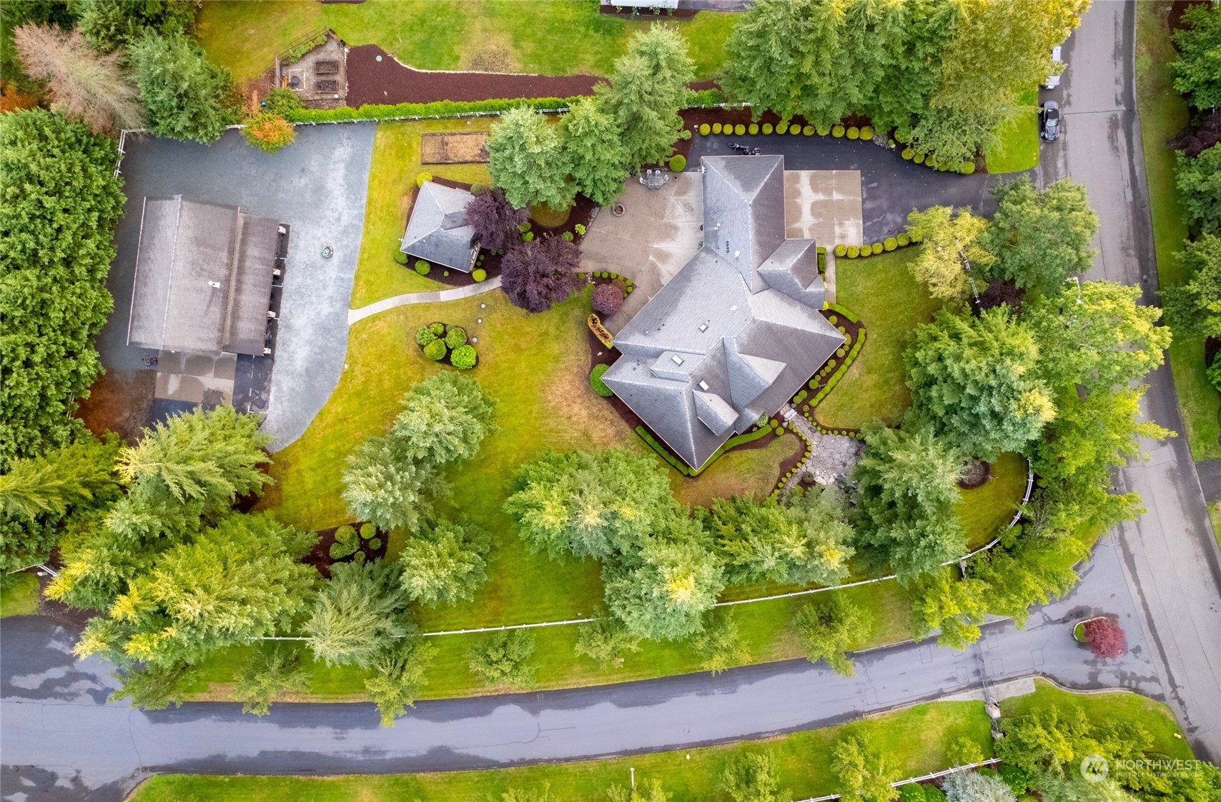 an aerial view of a house with a yard and swimming pool