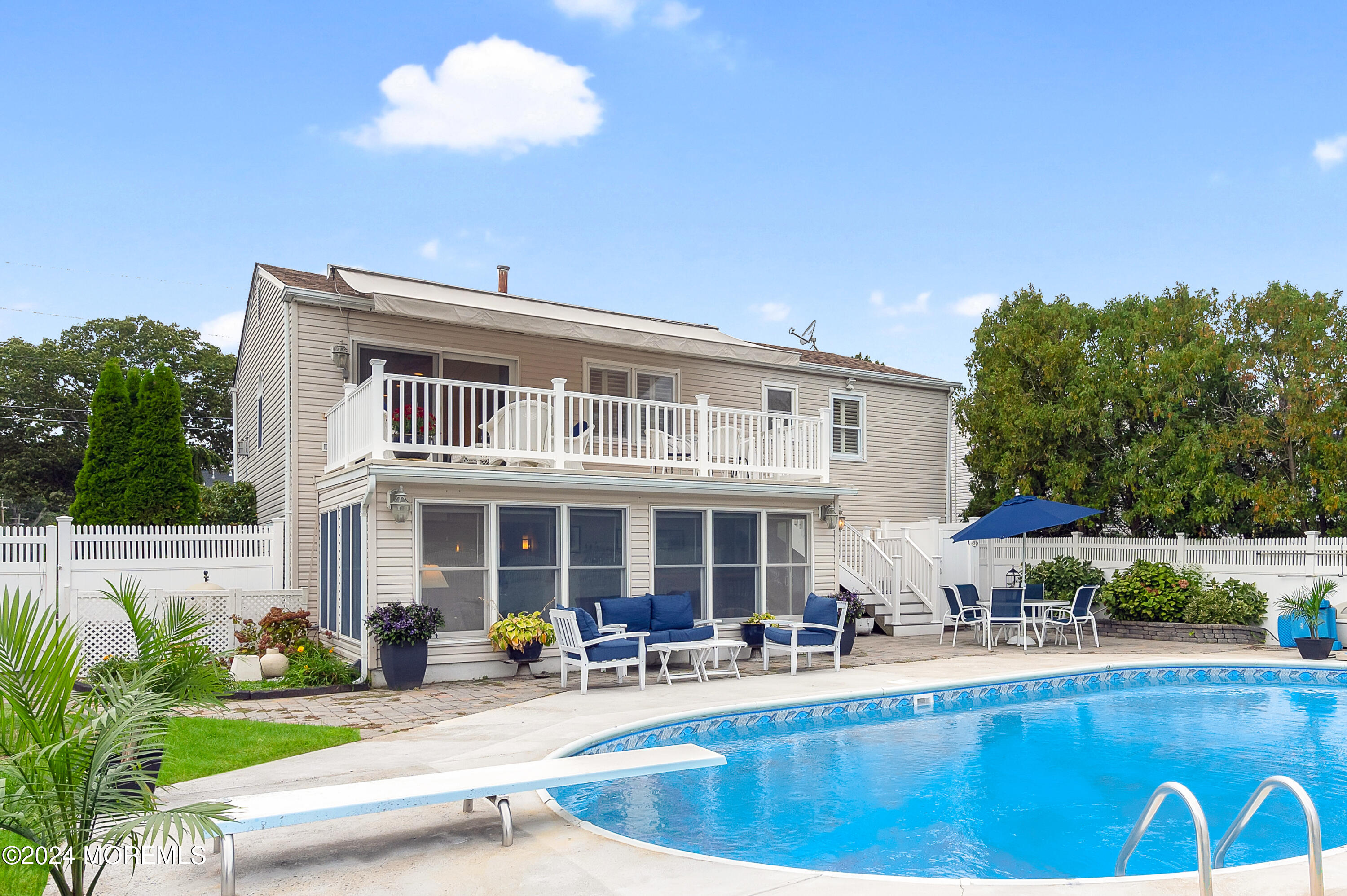 a view of a house with swimming pool and sitting area