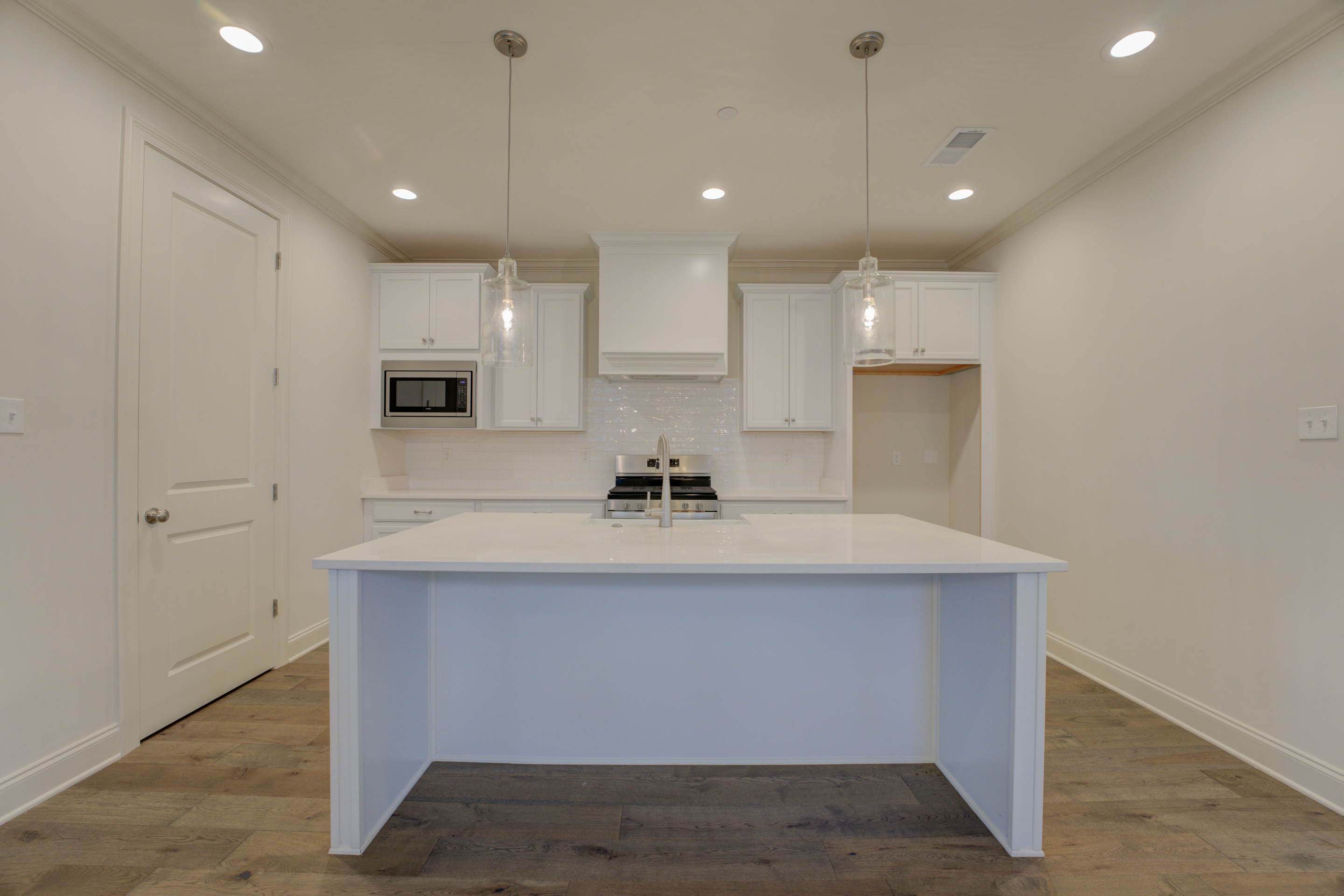 a view of cabinets a sink and dishwasher with wooden floor