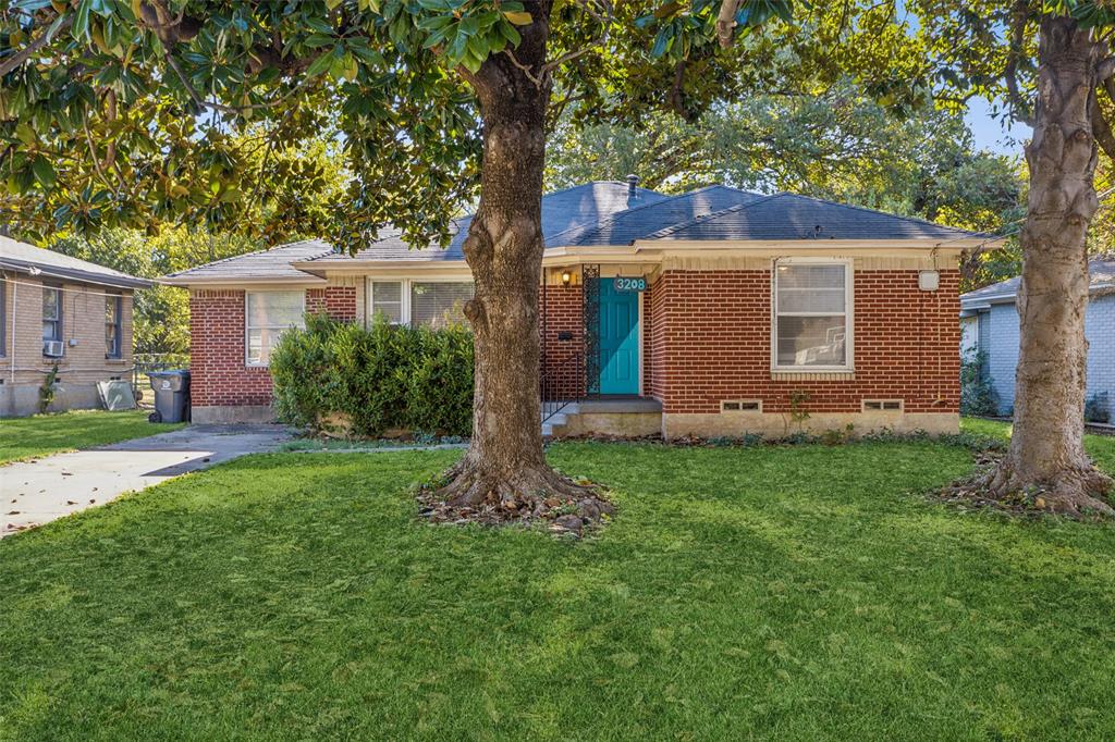 a front view of house with yard and trees