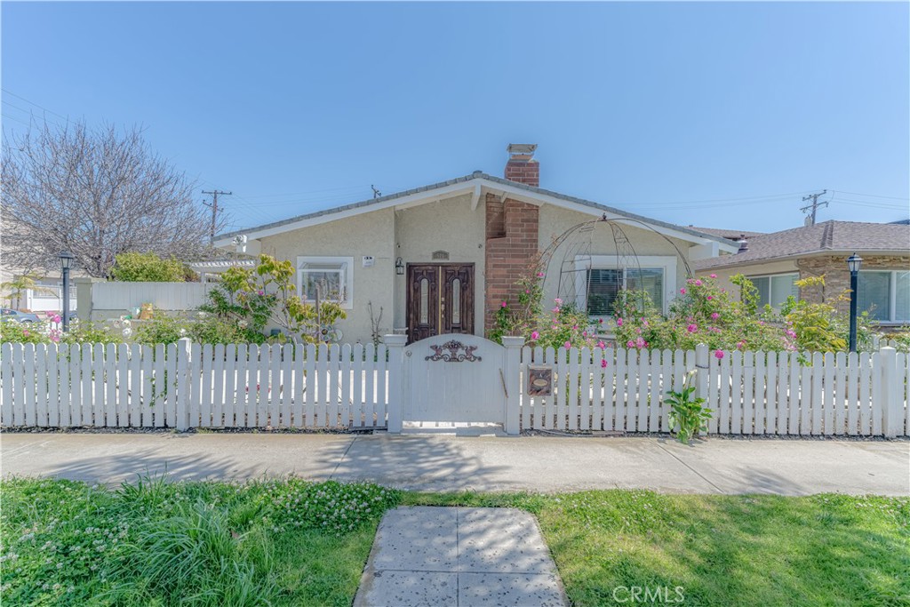 a front view of house with wooden fence