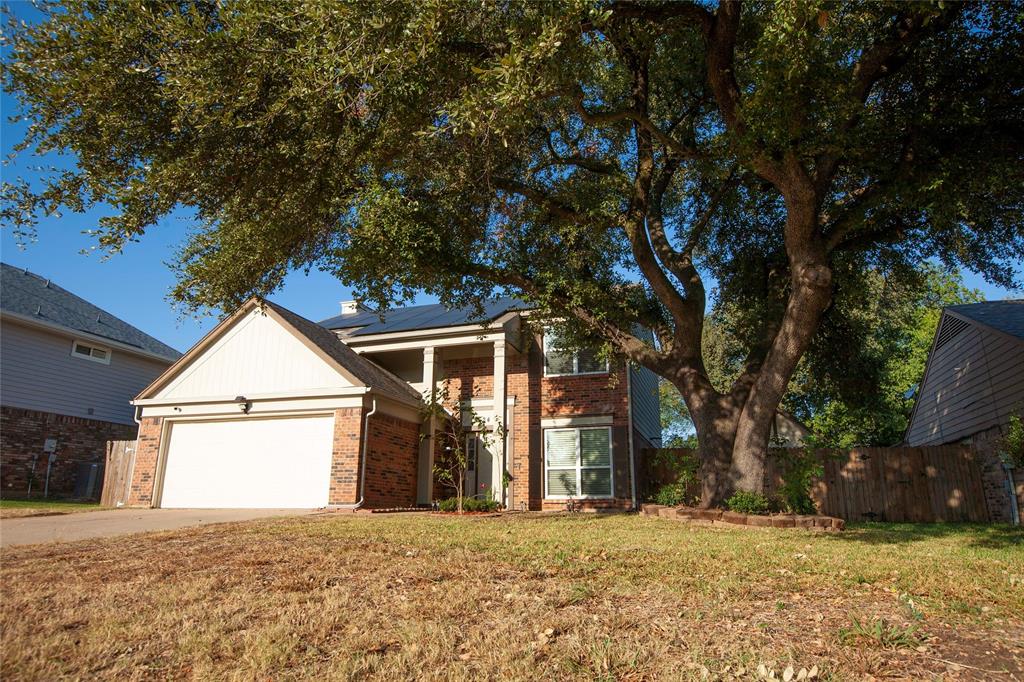 a view of a house with a yard and garage