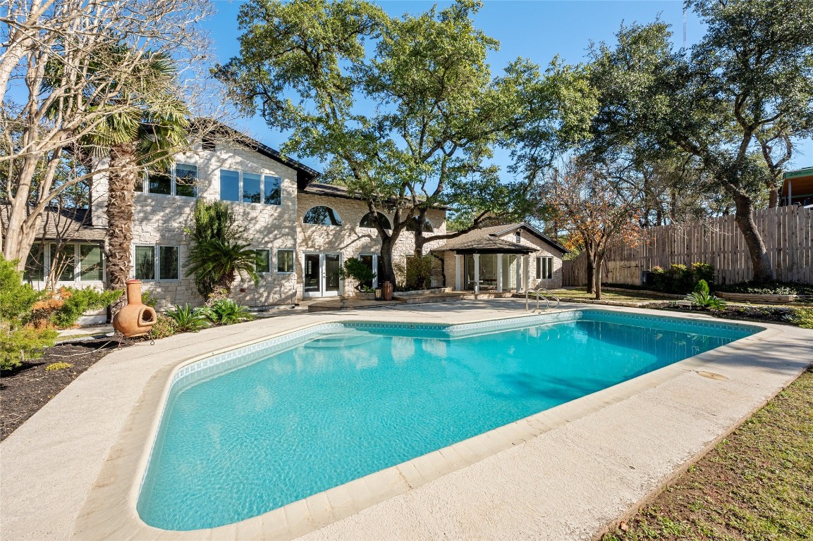 a swimming pool with outdoor seating and yard