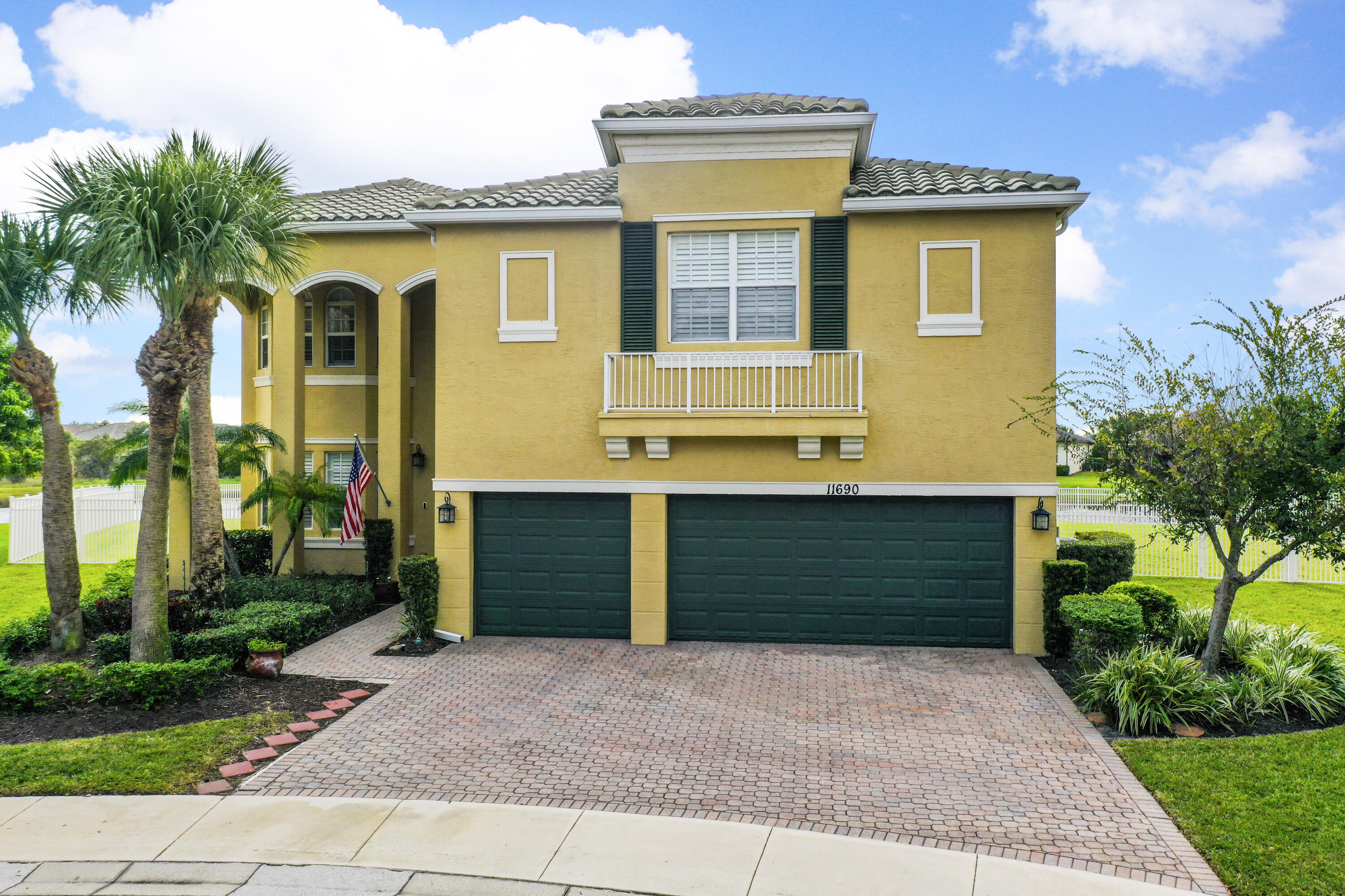 a front view of a house with a yard and a garage