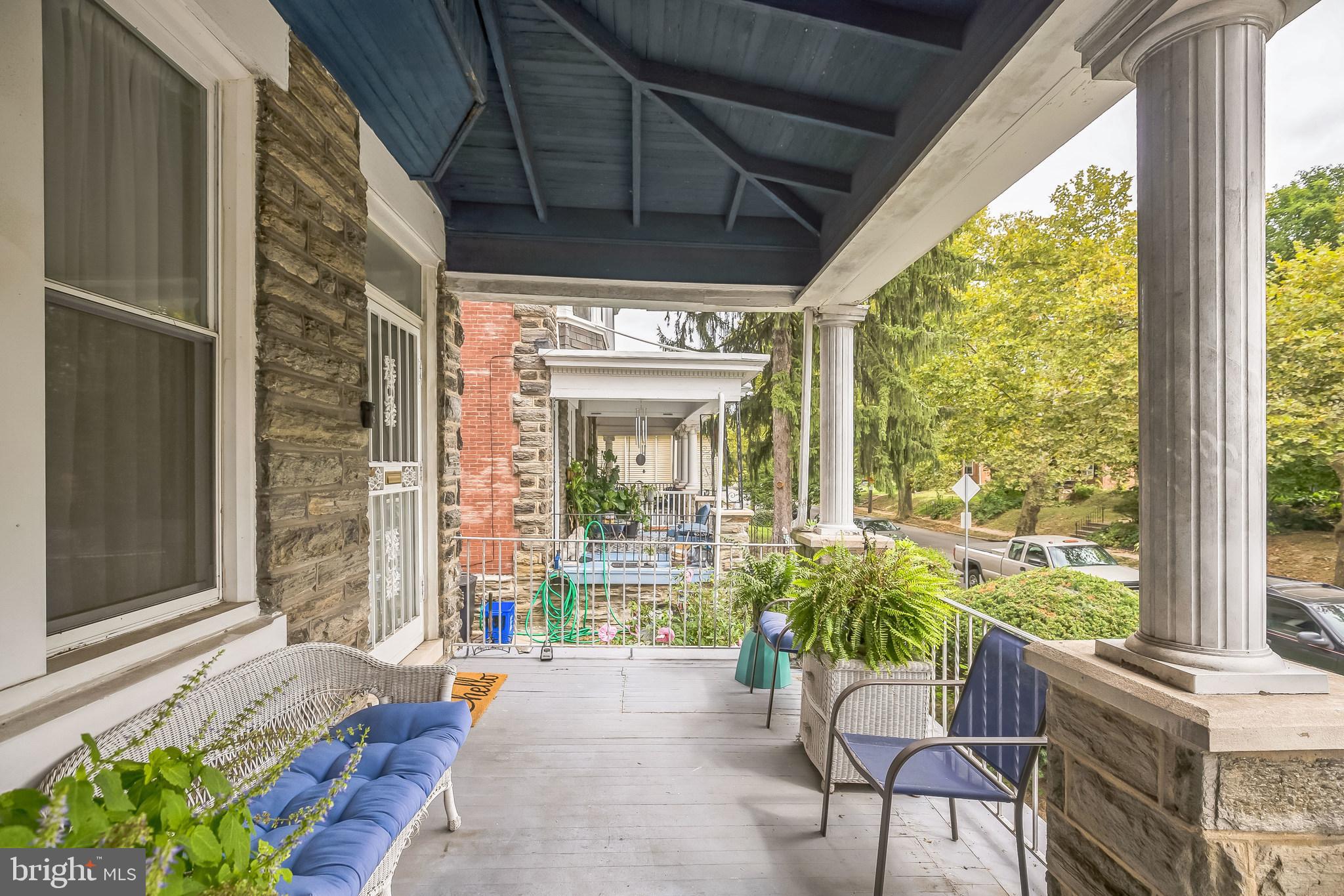 a view of a porch with furniture and garden