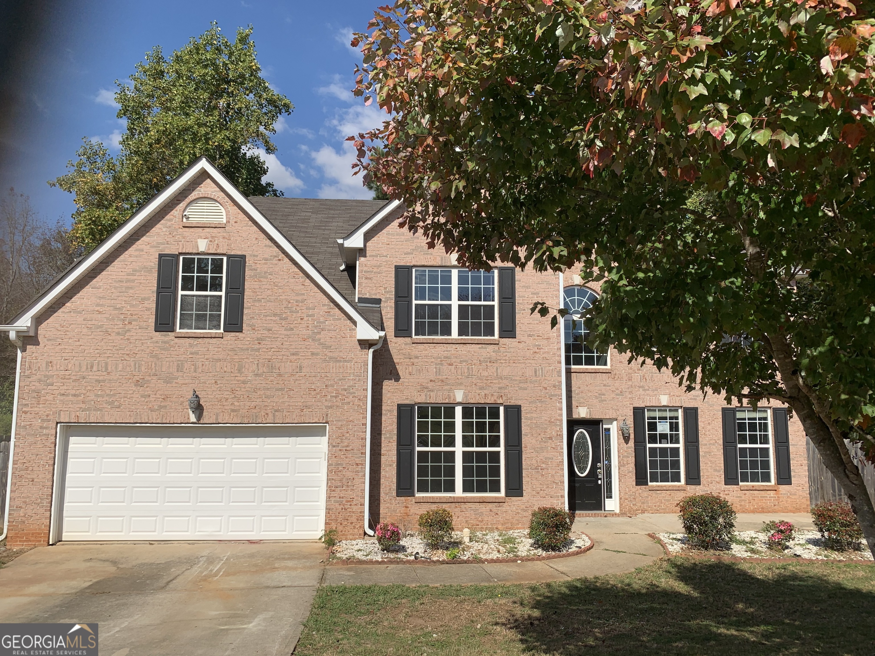 a front view of a house with yard