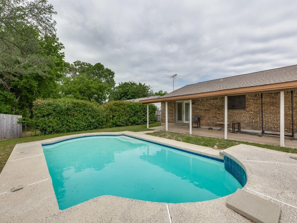 a view of a swimming pool with a yard