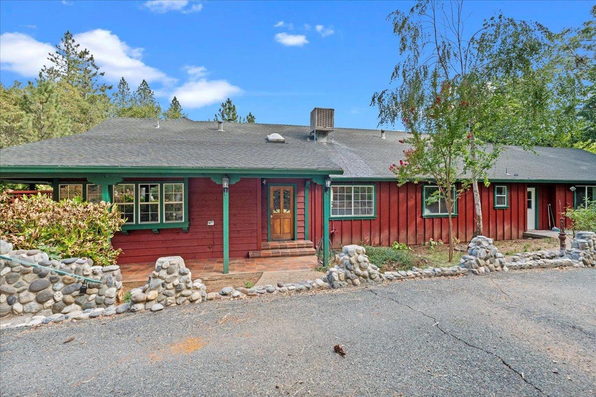 a front view of a house with basket ball court and outdoor seating