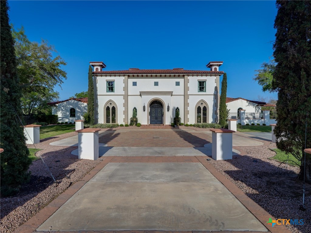 a view of a white house with a yard