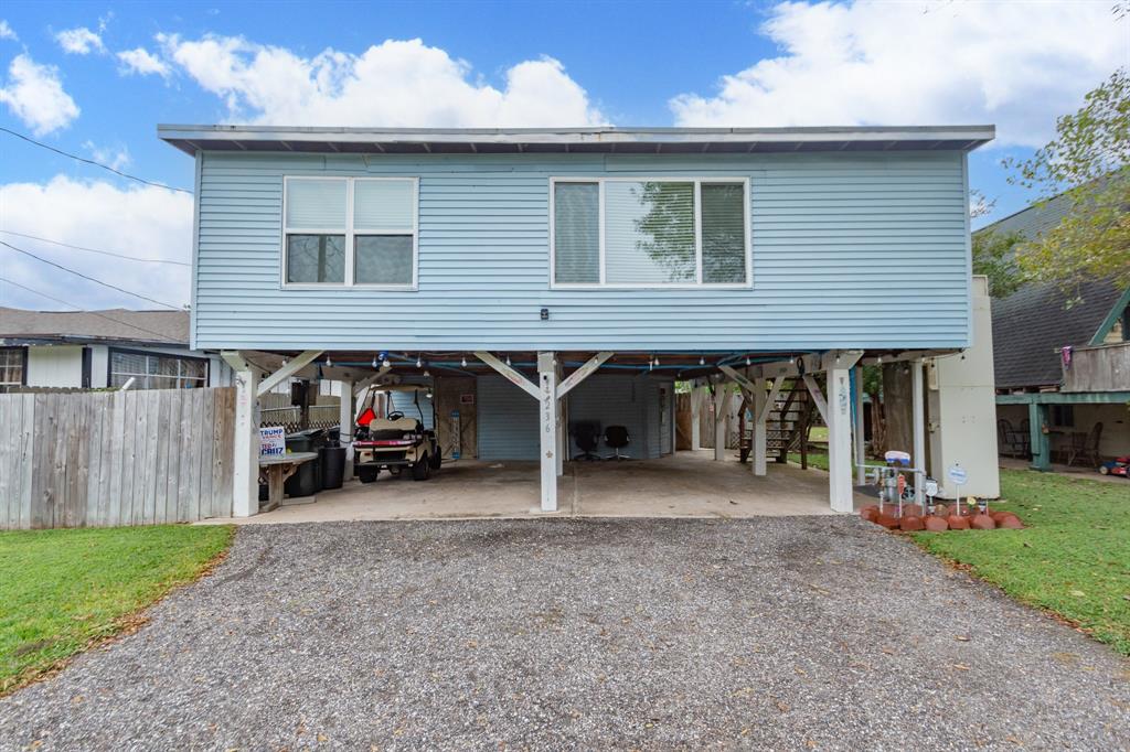 a view of a house with a patio and a yard