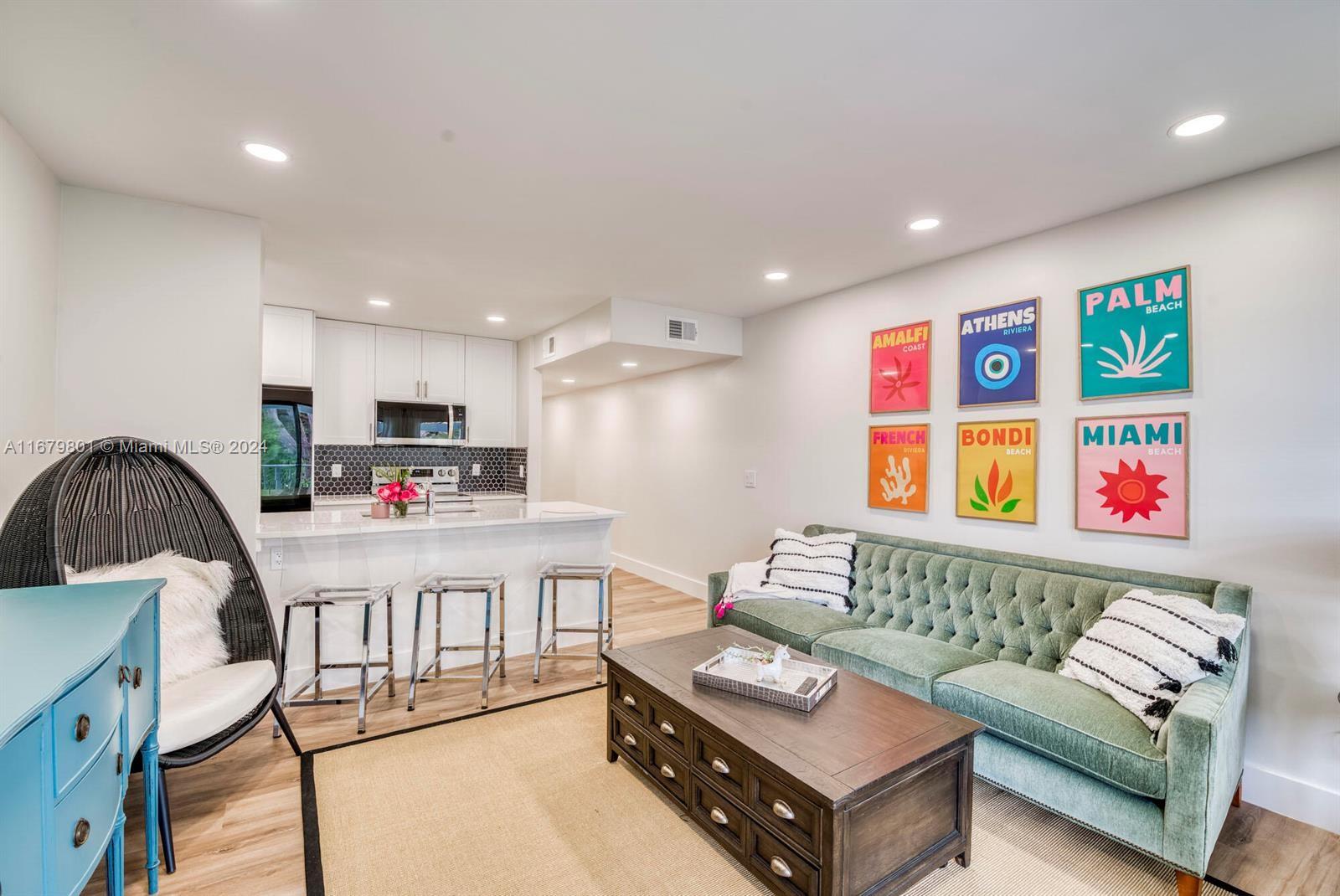 a living room with furniture and a kitchen view