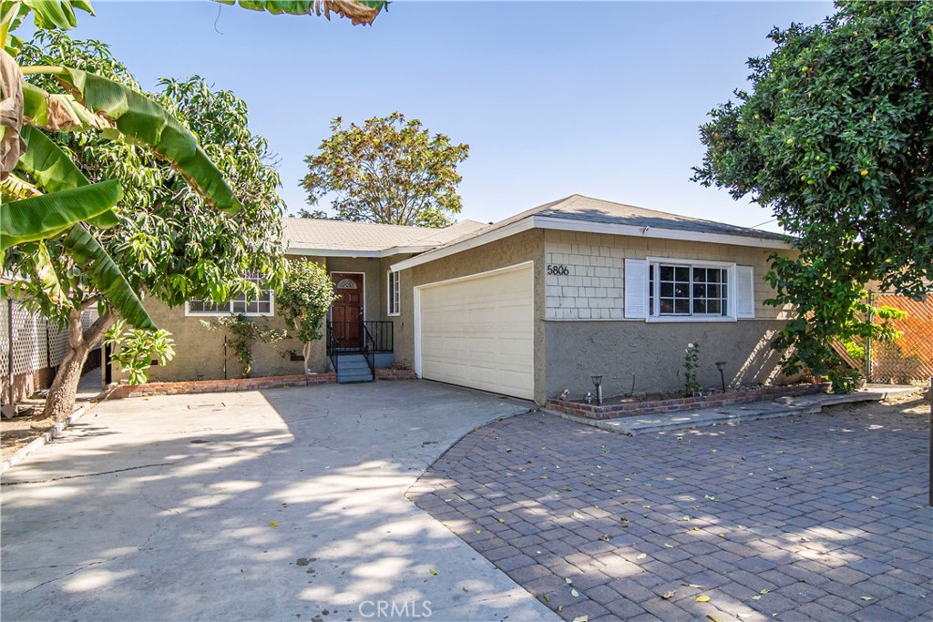 a view of a house with a yard and tree