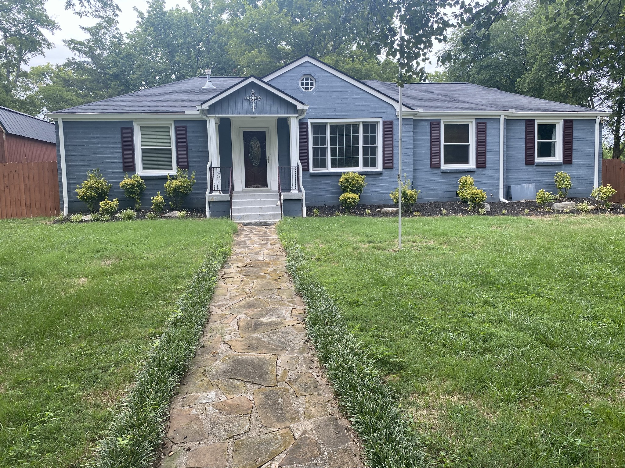 a front view of house with yard and green space