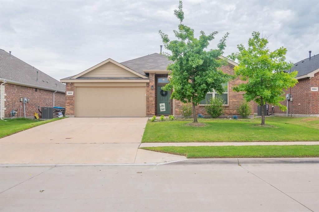 a front view of a house with a yard and a garage