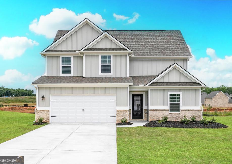 a front view of a house with a yard and garage