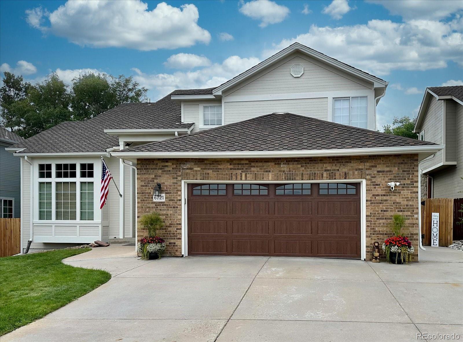 a front view of a house with a yard and garage