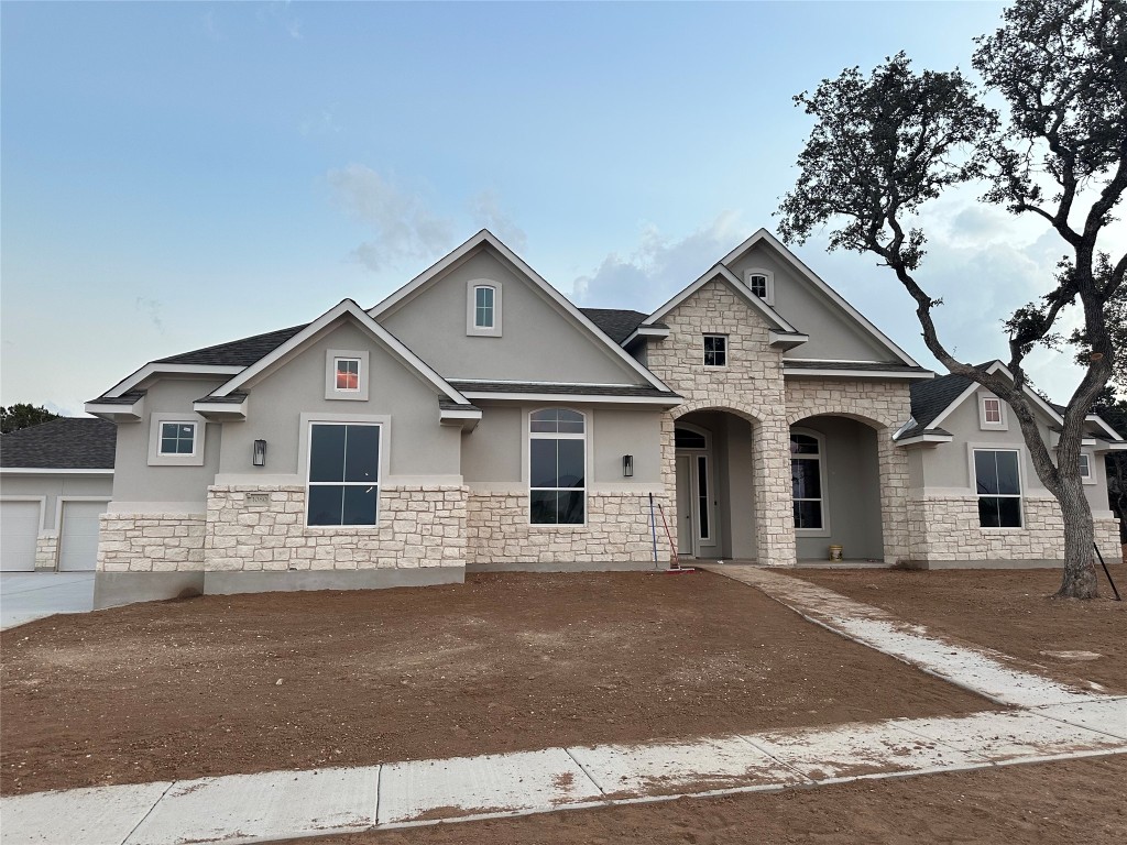 a front view of a house with a garage