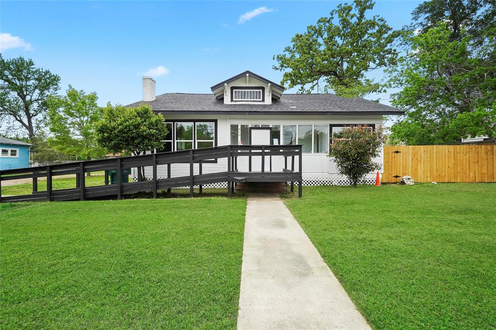 a front view of a house with a yard table and chairs