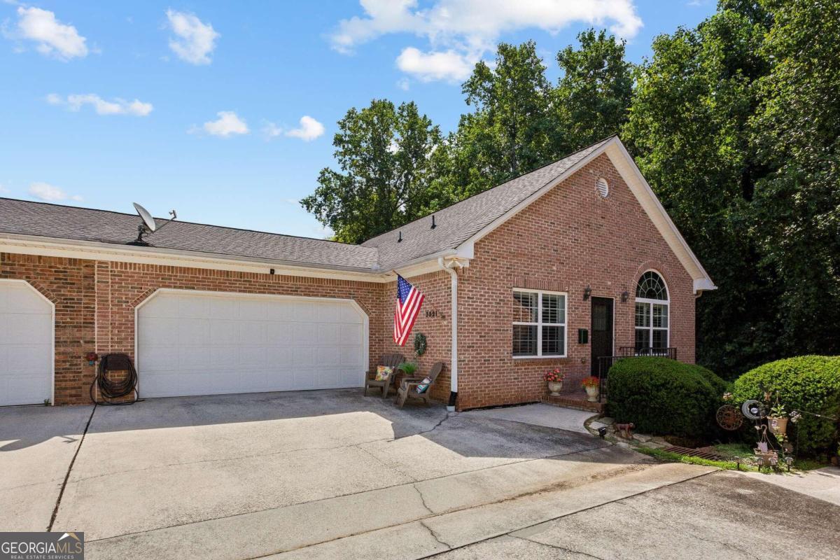 a view of a house with large space and a garage