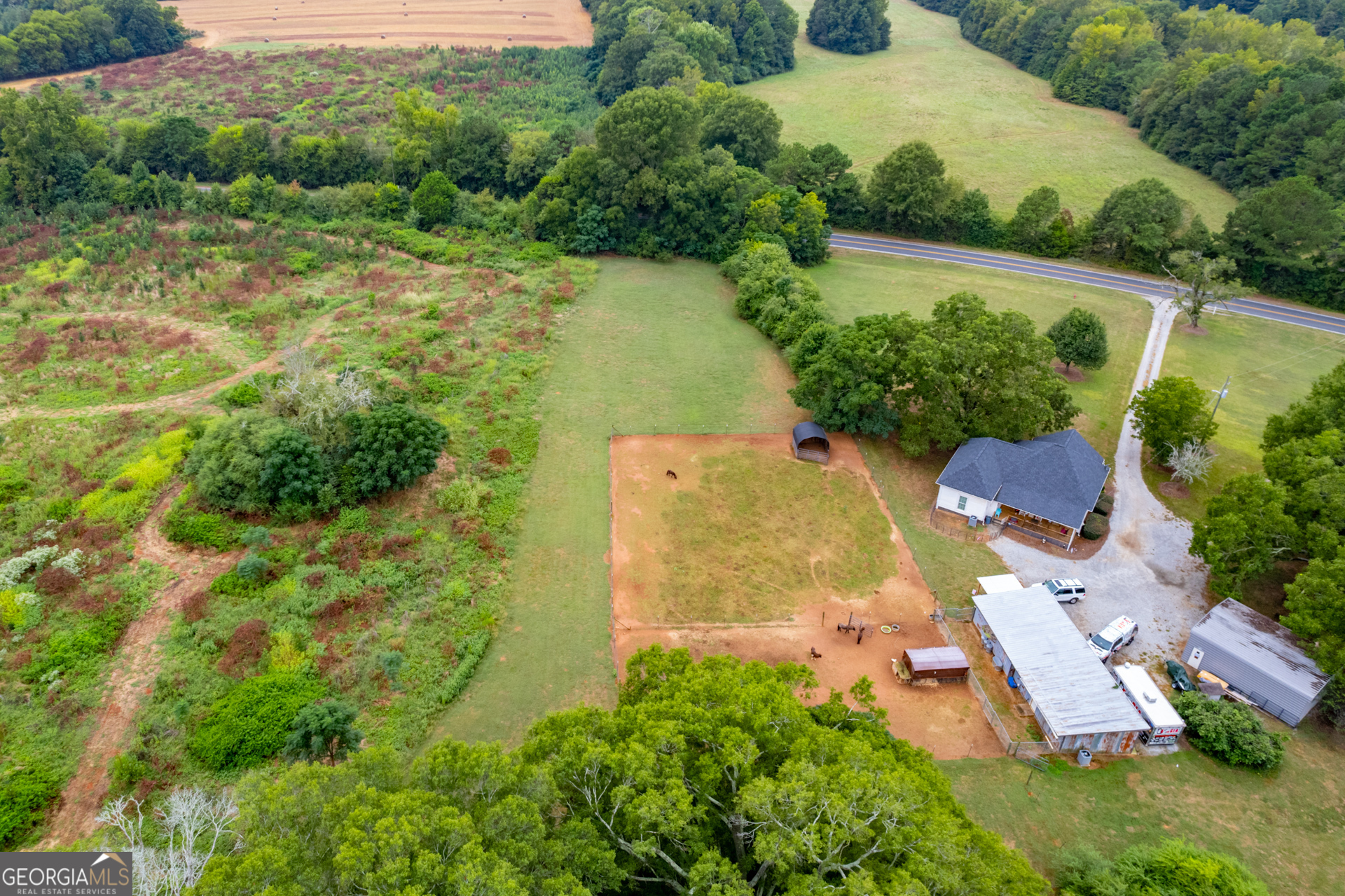 an aerial view of residential house with outdoor space and swimming pool